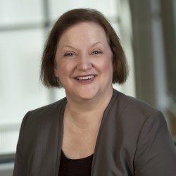 Barbara Kochanowski Headshot in grey blazer and black blouse
