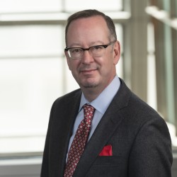 David Spangler Headshot in suit and red tie