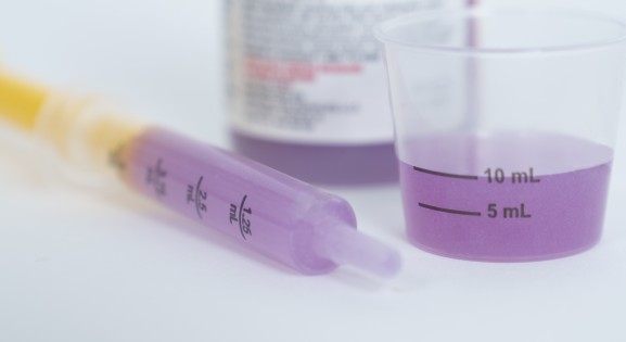 Medicine bottle, dosing cup, and medicine syringe