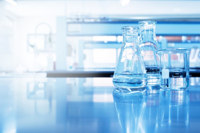 two flasks and a beaker on a table in a lab
