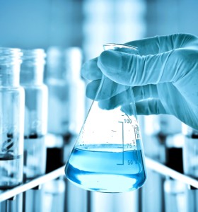 Flask with Chemicals in Gloved Hand
