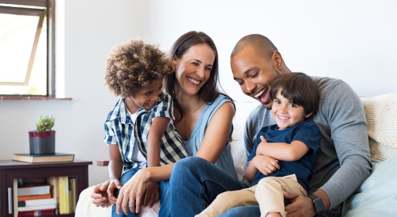 multi-racial couple with two children in living room